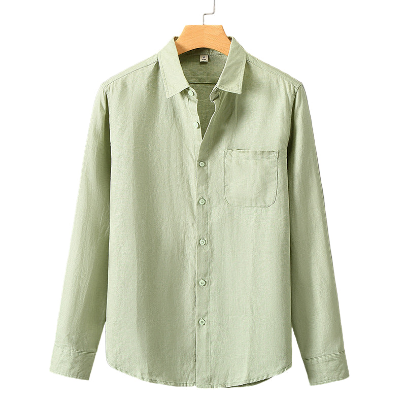 Light green shirt on a hanger against a gray background