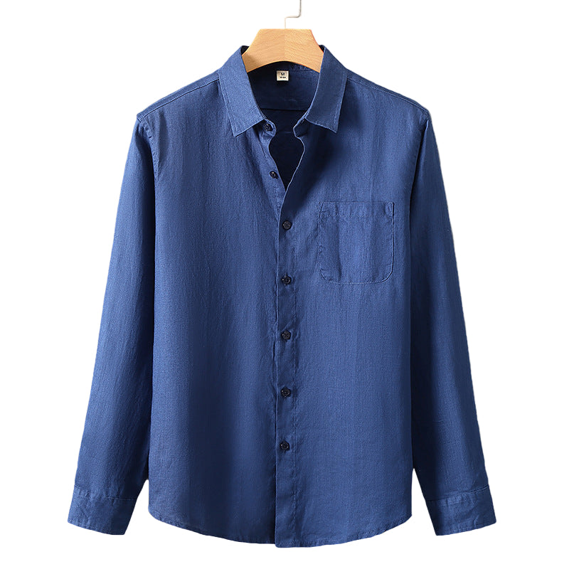 Blue shirt on a hanger against a gray background
