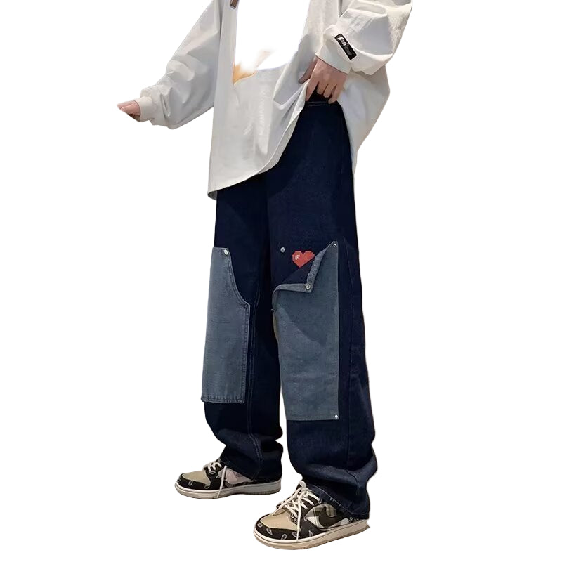 Person wearing a white shirt and blue jeans with a heart design.