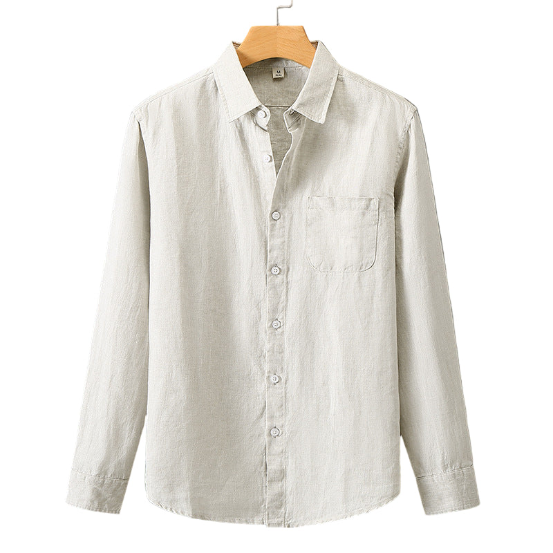 Light-colored shirt on a wooden hanger against a gray background