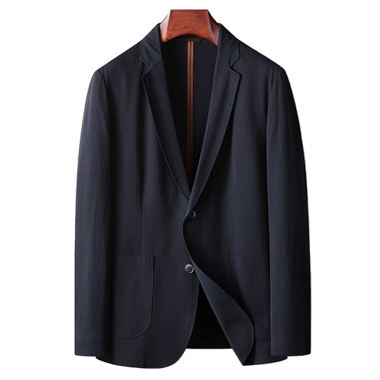Dark blue blazer on a wooden hanger against a gray background