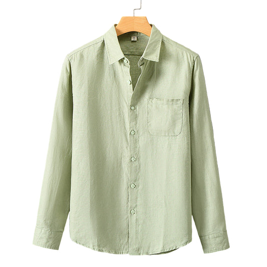 Light green shirt on a hanger against a gray background