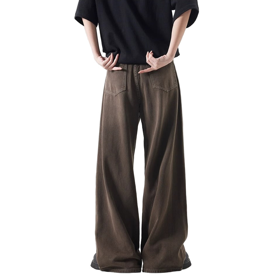 Person wearing brown wide-leg pants and a black top on a white background