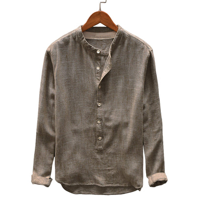 Brown button-up shirt on a wooden hanger against a gray background