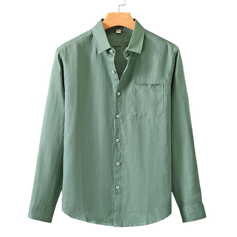 Green shirt on a hanger against a gray background