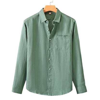 Green shirt on a hanger against a gray background