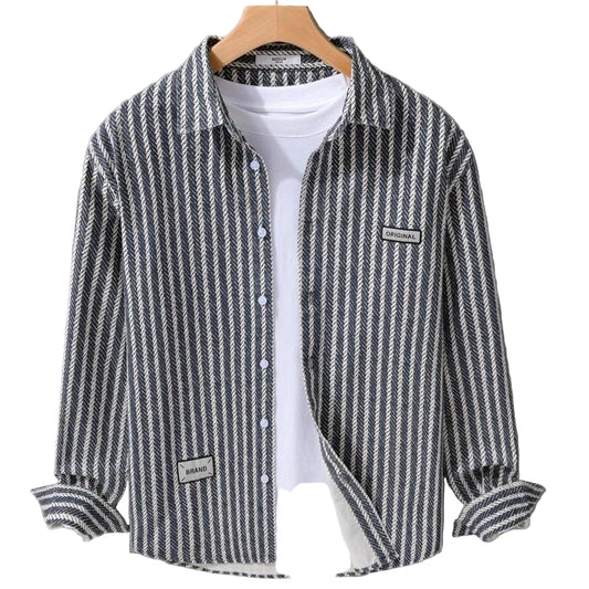 Striped shirt on a hanger against a gray background