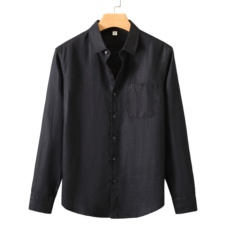 Black button-up shirt on a hanger against a gray background
