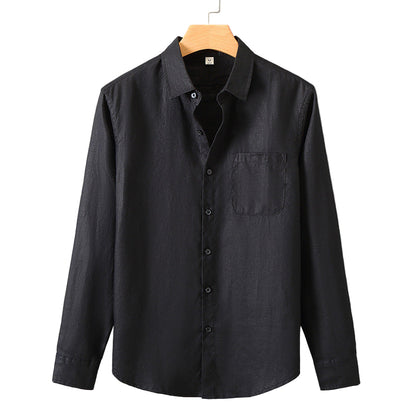 Black button-up shirt on a hanger against a gray background