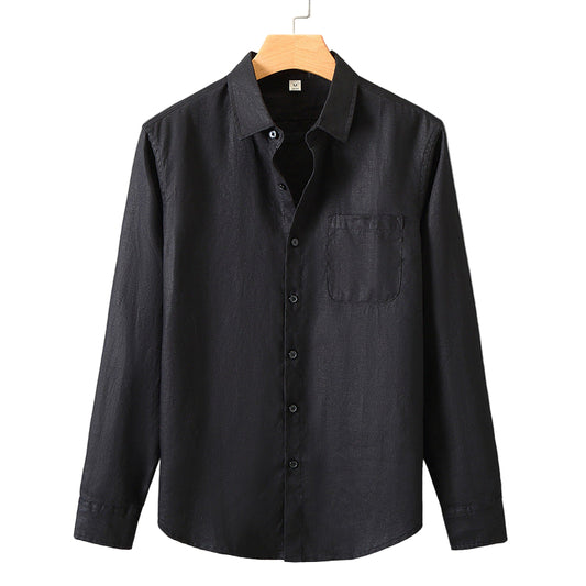 Black button-up shirt on a hanger against a gray background