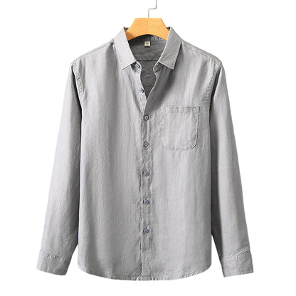 Light gray button-up shirt on a hanger against a gray background