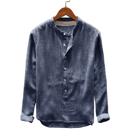 Blue denim shirt on a wooden hanger against a light gray background