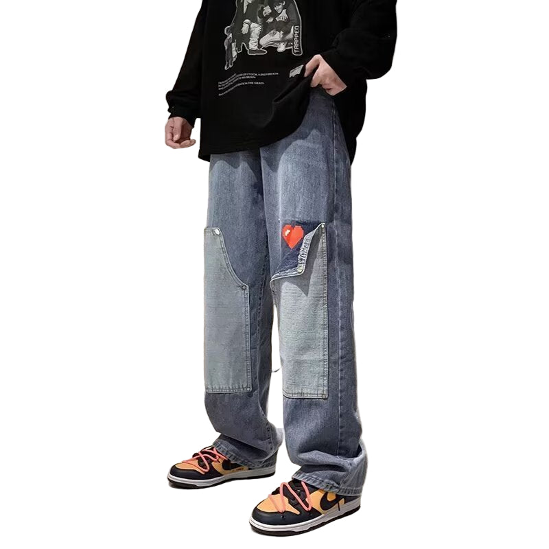 Person wearing blue jeans with a heart patch in an indoor setting