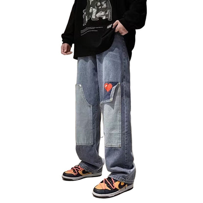 Person wearing blue jeans with a heart patch in an indoor setting