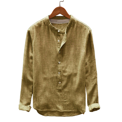 Green shirt on a wooden hanger against a gray background